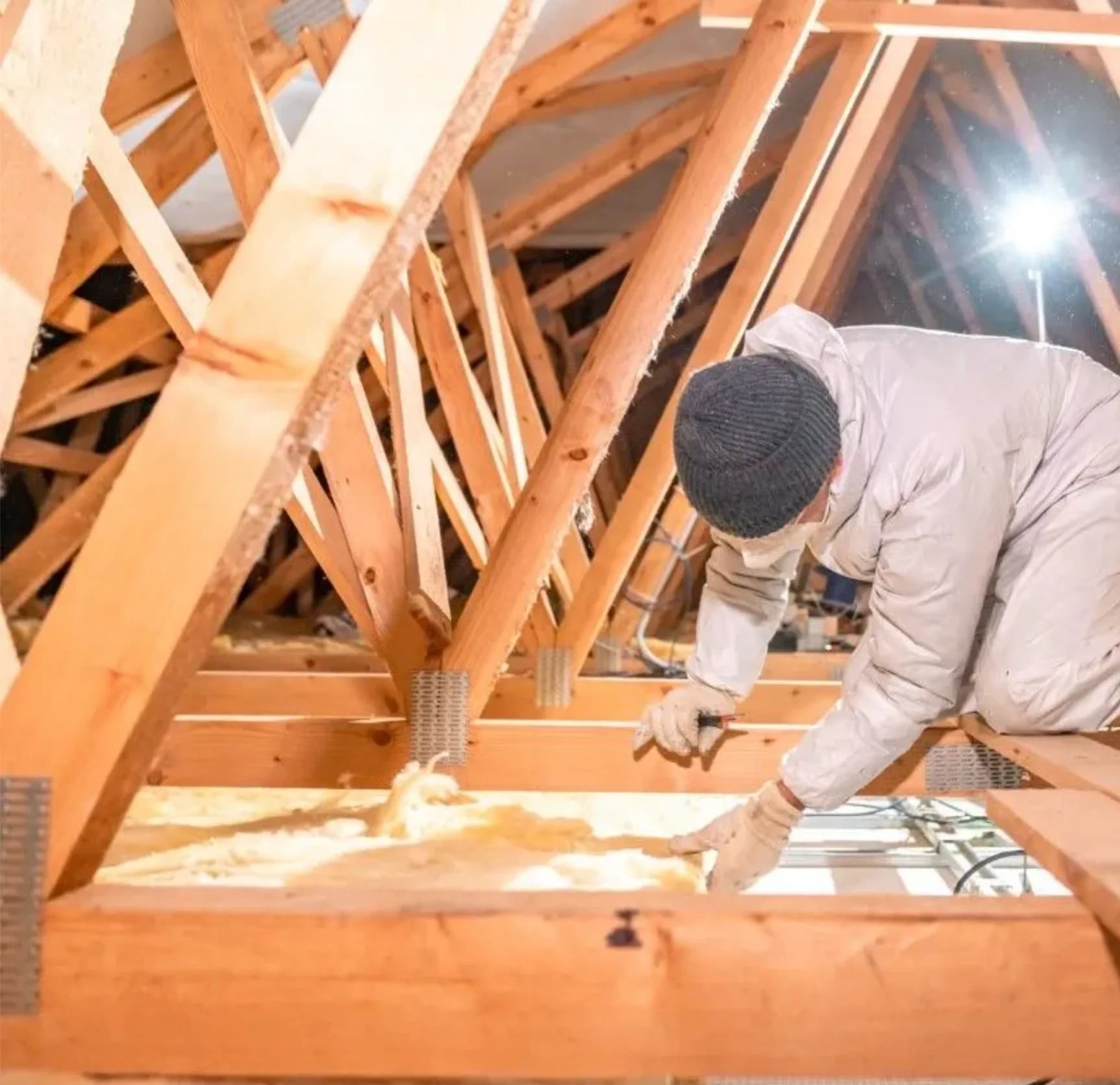 Attic spray foam installer Vancouver Installer preparing attic framing for spray foam insulation in Vancouver