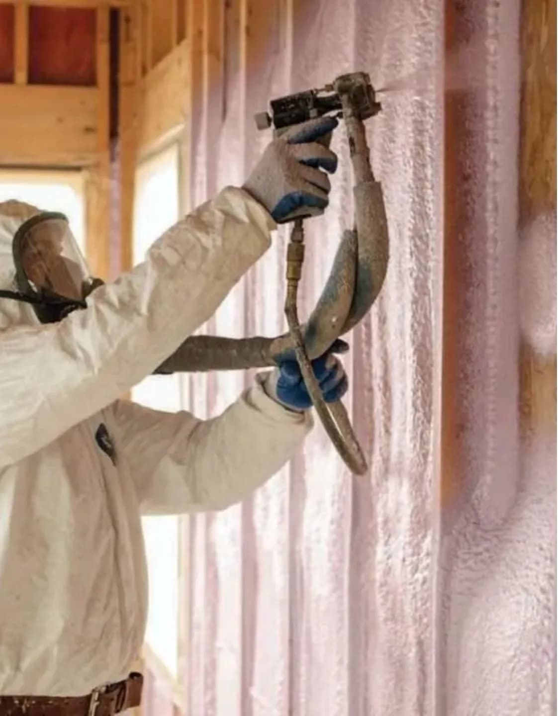 Spray foam wall application in Vancouver Installer spraying closed-cell spray foam insulation into wall framing in Vancouver